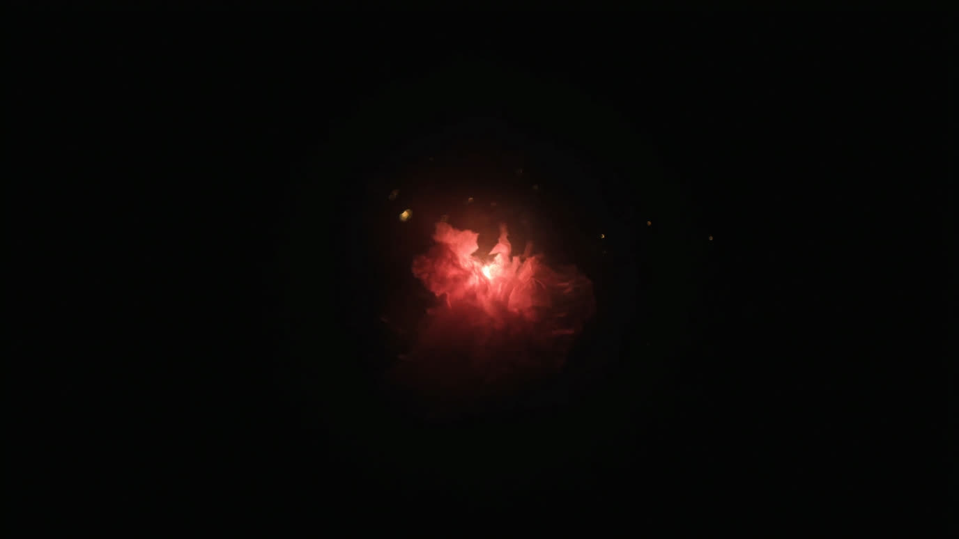 A soft bloom of warm coral light opening out of deep ink-black darkness.